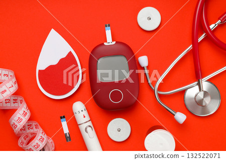 Diabetes supplies: glucose meter and stethoscope, top view 132522071