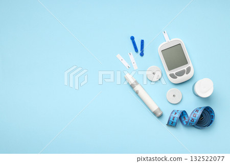 Glucometer and insulin pen on a blue background 132522077