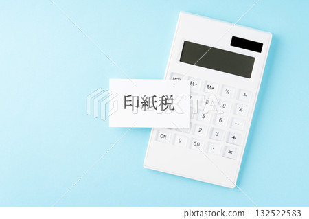 Stamp duty text and calculator on light blue background Stamp duty text and calculator on light blue background 132522583