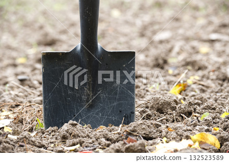 Close up of a shovel in the soil, ready for gardening or agricultural work Close up of a shovel in the soil, ready for gardening or agricultural work 132523589