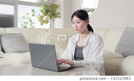 Asian woman typing Asian woman typing 132523963