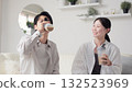 Asian men and women drinking protein in the living room 132523969