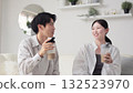 Asian men and women drinking protein in the living room 132523970