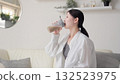 Asian woman drinking protein in the living room 132523975