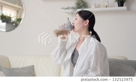 亞洲女性在客廳喝蛋白質 132523975