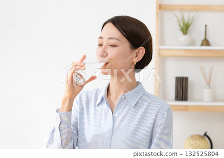 A woman drinking water A woman drinking water 132525804