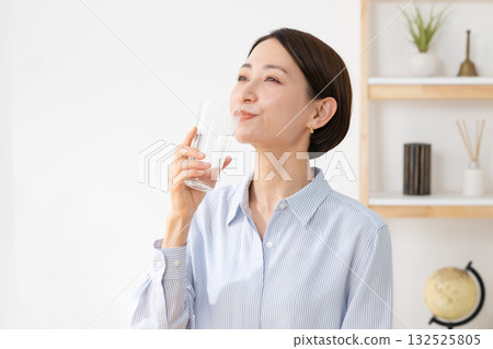 A woman drinking water 132525805