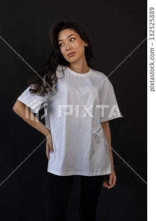 White shirt in studio, Versatile mockup of confident model in white T shirt highlighting fabric White shirt in studio, Versatile mockup of confident model in white T shirt highlighting fabric 132525889