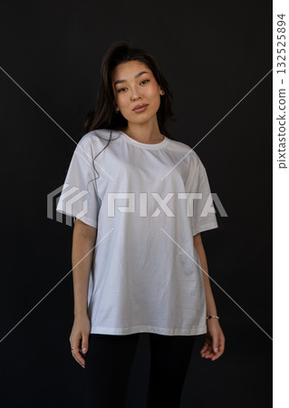 White shirt in studio, Versatile mockup of confident model in white T shirt highlighting fabric White shirt in studio, Versatile mockup of confident model in white T shirt highlighting fabric 132525894