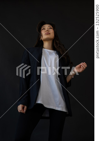 Editorial style image capturing clothing textures with poised model and gentle illumination Editorial style image capturing clothing textures with poised model and gentle illumination 132525900