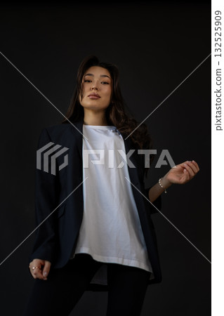 Editorial style image capturing clothing textures with poised model and gentle illumination 132525909