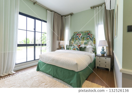 Stylish pale green and white bedroom in the master suite. Stylish pale green and white bedroom in the master suite. 132526136