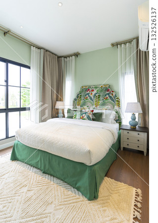 Stylish pale green and white bedroom in the master suite. 132526137