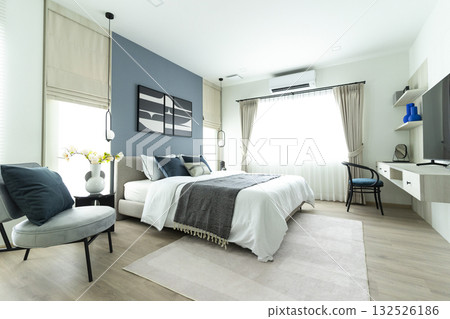 Stylish Bedroom in blue and white tone pillows setting. Cozy bedroom with art wall. Stylish Bedroom in blue and white tone pillows setting. Cozy bedroom with art wall. 132526186