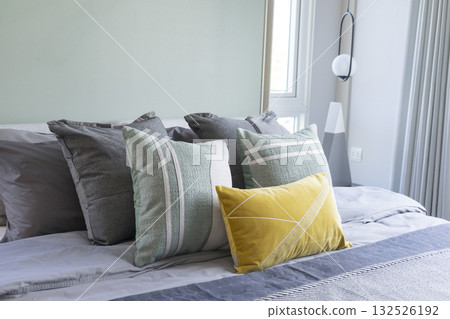 Stylish Bedroom in blue and white tone pillows setting. Cozy bedroom with art wall. Stylish Bedroom in blue and white tone pillows setting. Cozy bedroom with art wall. 132526192