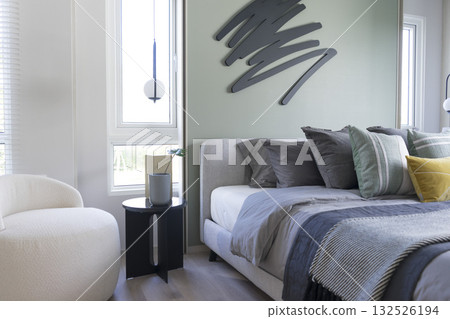 Stylish Bedroom in blue and white tone pillows setting. Cozy bedroom with art wall. Stylish Bedroom in blue and white tone pillows setting. Cozy bedroom with art wall. 132526194