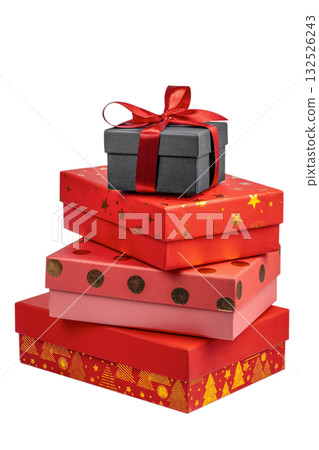 Stack of colorful gift boxes with Christmas decorations, including a black box tied with a red satin ribbon on top and red boxes with festive gold patterns and dots below, isolated on white 132526243