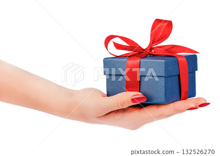 Female hand holding small blue gift box with red satin ribbon bow isolated on white background elegant holiday concept for birthday, Christmas, Valentines Day, or romantic celebration design Female hand holding small blue gift box with red satin ribbon bow isolated on white background elegant holiday concept for birthday, Christmas, Valentines Day, or romantic celebration design 132526270
