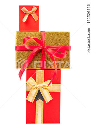 Vertical stack of elegant red and gold gift boxes decorated with satin bows and ribbons, symbolizing luxury celebration and holiday spirit, isolated on white background 132526326