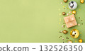 Christmas gift with ornaments on a green background 132526350