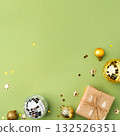 Christmas gift with ornaments on a green background 132526351