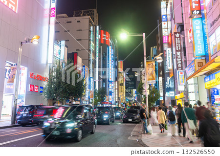 Tokyo: Shinjuku East Exit, a bustling shopping district lit by neon lights Tokyo: Shinjuku East Exit, a bustling shopping district lit by neon lights 132526550