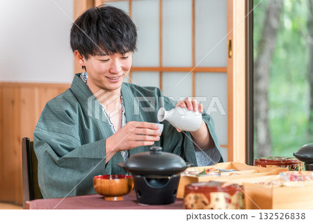 Young Asian man enjoying kaiseki cuisine at a ryokan (room service, kaiseki cuisine, gozen, luxury) Young Asian man enjoying kaiseki cuisine at a ryokan (room service, kaiseki cuisine, gozen, luxury) 132526838