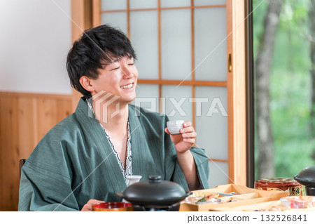 Young Asian man enjoying kaiseki cuisine at a ryokan (room service, kaiseki cuisine, gozen, luxury) Young Asian man enjoying kaiseki cuisine at a ryokan (room service, kaiseki cuisine, gozen, luxury) 132526841