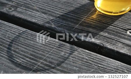 Shadow of a plastic cup filled with beer 132527107