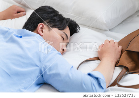 A young man who falls asleep in bed and wakes up in the morning A young man who falls asleep in bed and wakes up in the morning 132527733