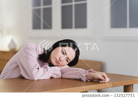 Young woman leaning face down on the table Lifestyle image 132527751