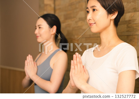 Two young women doing hot yoga. Beauty image. 132527772