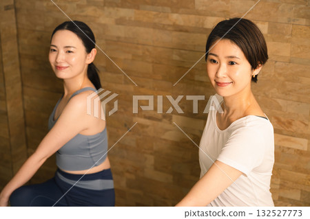 Two young women doing hot yoga. Beauty image. 132527773