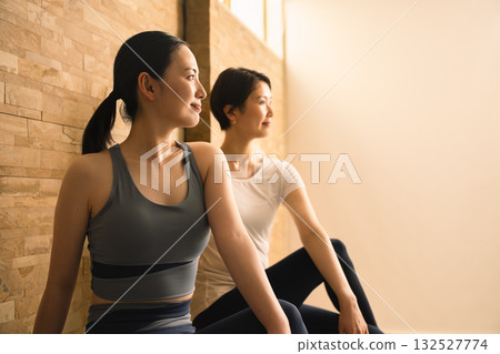 Two young women doing hot yoga. Beauty image. 132527774