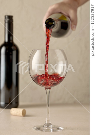 closeup of red wine pouring in glass 132527917