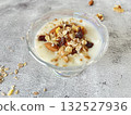 Yogurt topped with nuts and dried fruits. A healthy and nutritious breakfast. 132527936