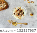 Yogurt topped with nuts and dried fruits. A healthy and nutritious breakfast. 132527937