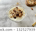 Yogurt topped with nuts and dried fruits. A healthy and nutritious breakfast. 132527939