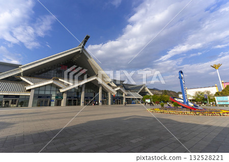 Lijiang, China - April 10, 2024 : View of the main building of Lijiang Railway Station in Lijiang, China on April 10, 2024. Lijiang, China - April 10, 2024 : View of the main building of Lijiang Railway Station in Lijiang, China on April 10, 2024. 132528221