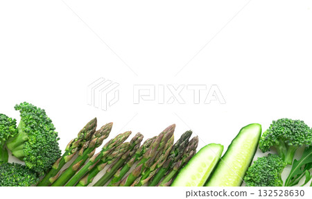 frame of green vegetables broccoli, arugula, cucumber, asparagus and garlic on white background 132528630