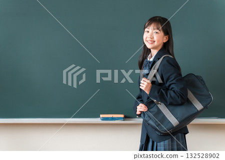 Female students in uniforms holding school bags standing in front of the blackboard in the classroom, elementary school, junior high school, and high school students Female students in uniforms holding school bags standing in front of the blackboard in the classroom, elementary school, junior high school, and high school students 132528902