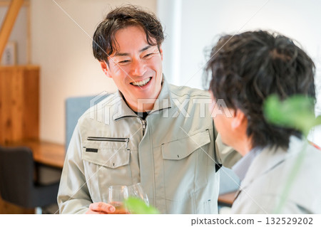 Businessmen in work clothes holding champagne and lining up in the office (teamwork, rally, victory party, celebration) 132529202