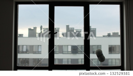 Washing of panoramic windows. Window cleaning robot. The assistant window cleaner robot moves on soft pads on the glass. Polishing of the glass surface. 132529381