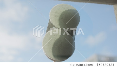 Close up automatic window cleaning robot operating on residential window. Simplicity and convenience of window cleaning. 132529383