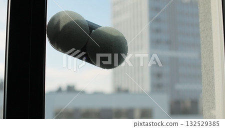 Robot window cleaner washes a window. Cleaning process with modern household appliances. Simplicity and convenience of window cleaning. Robot window cleaner washes a window. Cleaning process with modern household appliances. Simplicity and convenience of window cleaning. 132529385