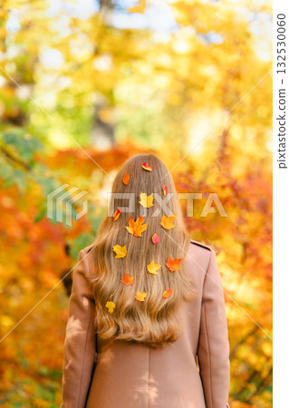 Woman with long blonde hair in an autumn park 132530060