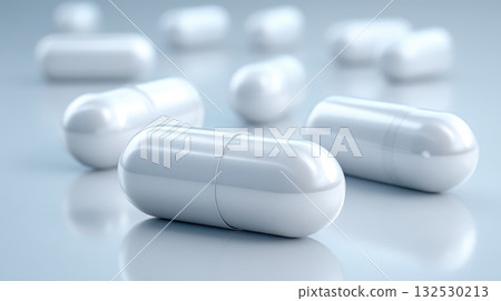 White capsule pharmaceutical drug development concept with close up of medicine pills on reflective surface showing health care and medical treatment White capsule pharmaceutical drug development concept with close up of medicine pills on reflective surface showing health care and medical treatment 132530213