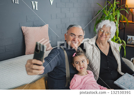 Grandparents and granddaughter share a joyful moment Grandparents and granddaughter share a joyful moment 132530391