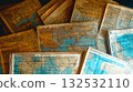 Vintage travel background with old map, passport, mobile phone, and travel books flat lay 132532110
