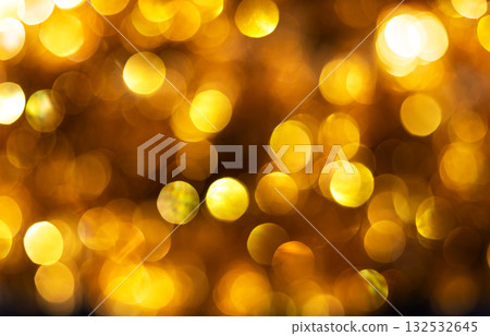 Golden bokeh background with soft glowing circles of light creating festive and luxurious atmosphere. Ideal for holiday designs, party invitations, luxury-themed visuals, celebration, elegance, warmth 132532645
